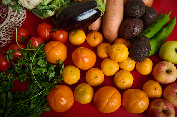 istock Vibrant Fresh Produce Display With Fruits, Vegetables, And Greens On Red Table 2247359516