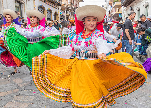 Cuenca, Ecuador – December 24, 2024: Pase del Niño Viajero (Traveling Child) Christmas procession in honor of the baby Jesus. A group of folk dancers in the historic center of Cuenca.