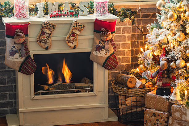 Glowing Christmas fireplace and living room, with tree, and stockings hanging from mantel by fireplace.Waiting for Santa.