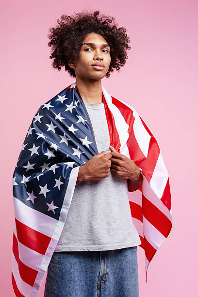 istock Serious African American man holding american flag looking at camera. Independence day concept 2247362011