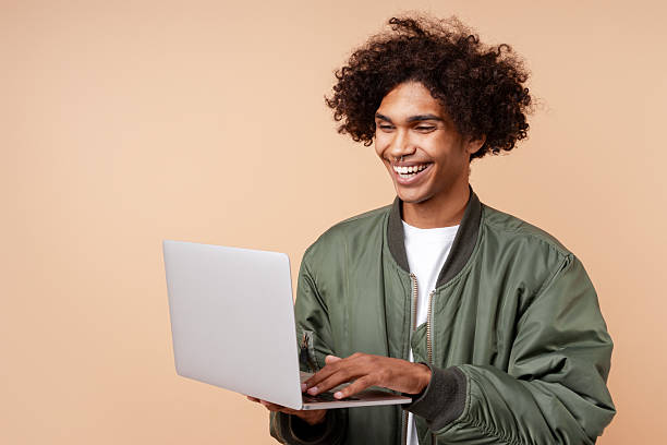 istock Happy, handsome African American man with piercing in nose copywriter typing on keyboard 2247362017