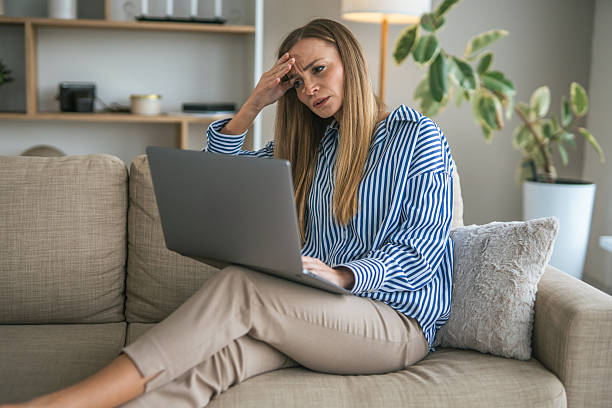 istock Stressed woman experiencing headache working remotely from home 2247366075
