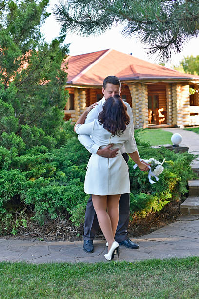 A mature couple, husband and wife, are celebrating their wedding anniversary with their children. A country recreation center on the shore of a lake, in September.