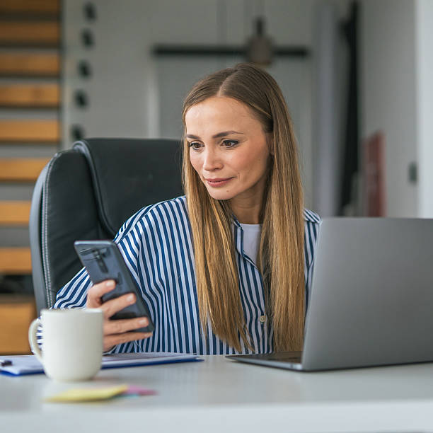 istock Woman working from home office using laptop and phone 2247367270