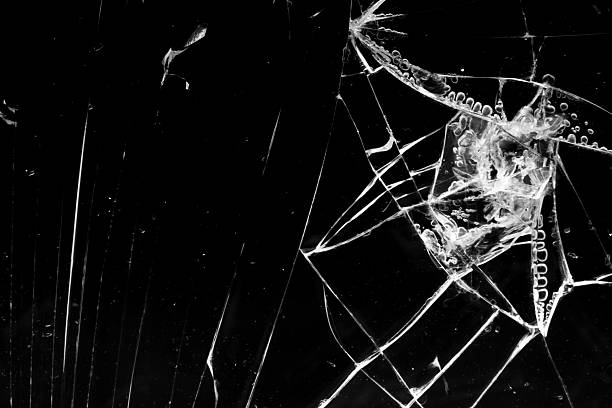 istock cracked glass isolated in black background 2247369213