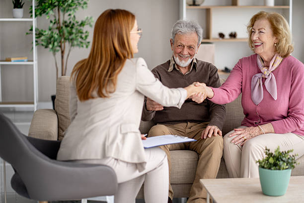 istock Friendly Meeting with Elderly Couple and Advisor at Home 2247371023