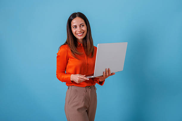 istock Woman smiling while using laptop, happy and confident professional holding computer for remote work 2247371123