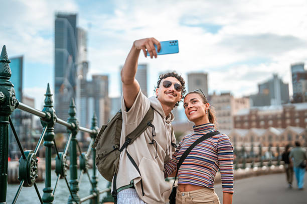 istock Smiling Couple Taking Selfie on Sydney Waterfront Bridge 2247371162
