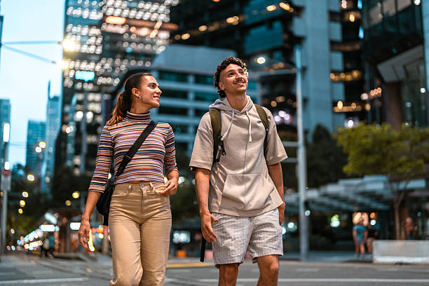 istock Young Hispanic Couple Walking Through Evening City Streets Together 2247371185