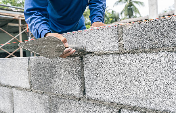 istock Hand worker masonry cement block brickwork trowel construction site wall concrete background 2247372252