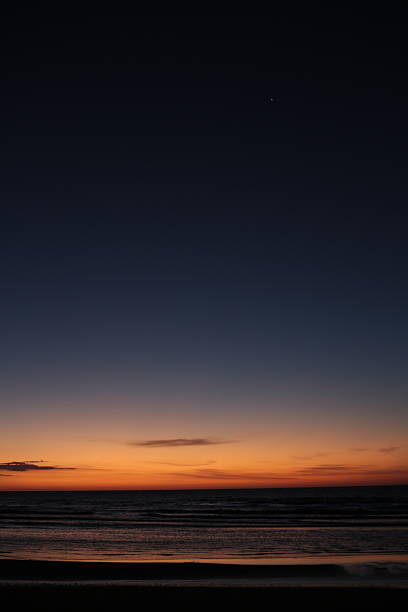 istock Vertical Shot of Deep Twilight Sea Horizon with Single Star 2247374268