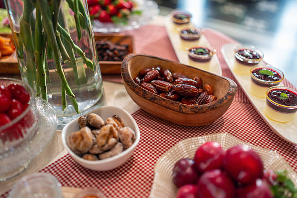 A close-up view of a self-service breakfast bar in a vintage boutique hotel, featuring diverse foods like fruits and pastries, set on a checkered tablecloth with soft-focus background.