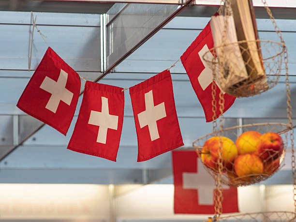 istock Swiss Flags Hanging in a Market with Fresh Apples 2247376980