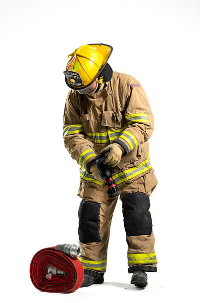 istock Portrait of a firefighter in protective uniform holding a firefighting and fire hose nozzle 2247380472