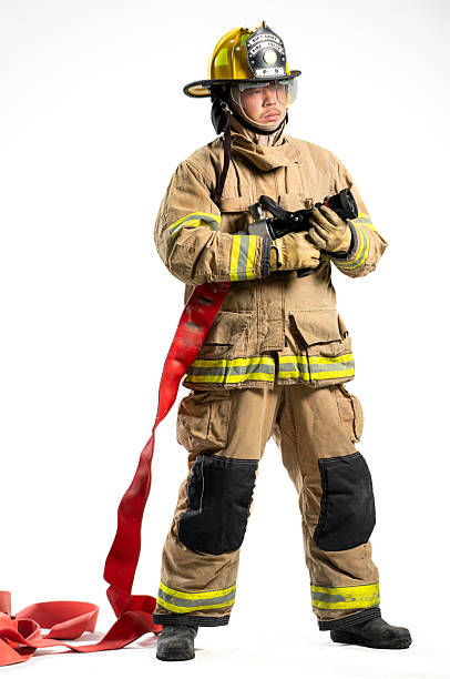 istock Portrait of a firefighter in protective uniform holding a firefighting and fire hose nozzle 2247380494