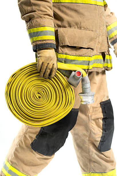 istock A close-up view of a firefighter holding a rolled yellow fire hose 2247380507