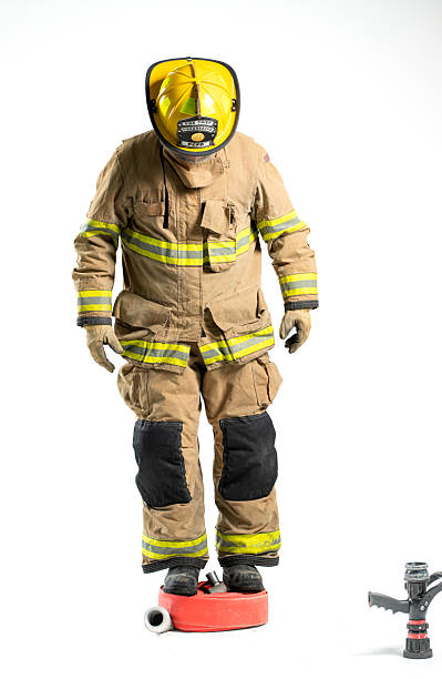 istock Portrait of a firefighter in protective uniform holding a firefighting and fire hose nozzle 2247380544