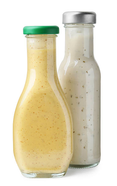 istock Different delicious sauces in glass bottles isolated on white 2247380814