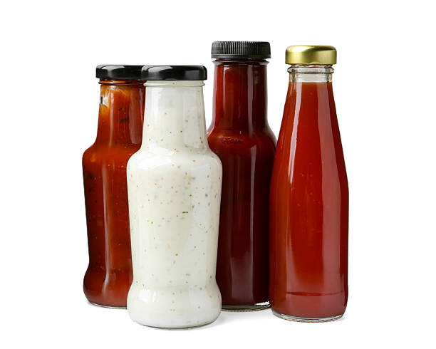 istock Different delicious sauces in glass bottles isolated on white 2247380815