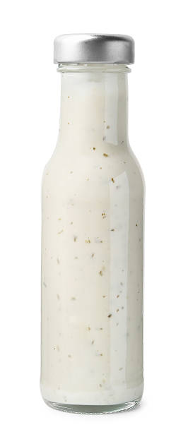 istock Delicious sauce in glass bottle isolated on white 2247380831
