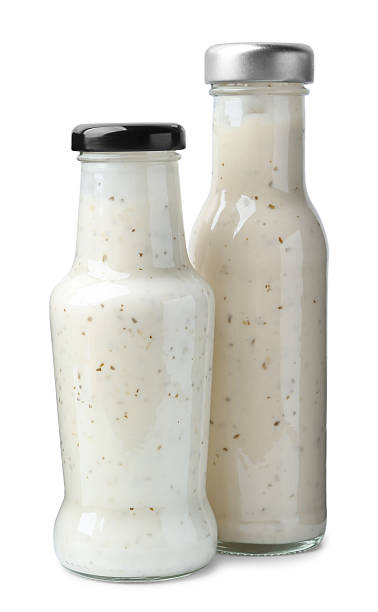 istock Different delicious sauces in glass bottles isolated on white 2247380866