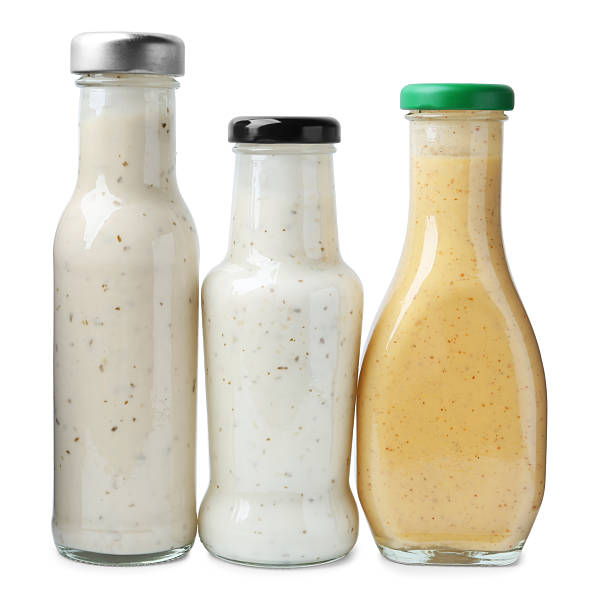 istock Different delicious sauces in glass bottles isolated on white 2247380937
