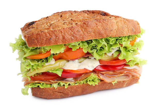 Delicious baguette sandwich with tomatoes and yellow beans isolated on white