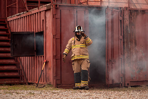 istock A firefighter in full protective gear takes a break after exiting a smoke-filled building 2247381042