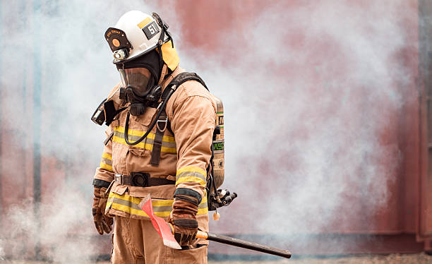 istock A firefighter in full protective gear takes a break after exiting a smoke-filled building 2247381105