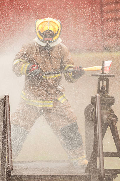 istock A firefighter in protective gear swings an axe while performing an emergency response 2247381214