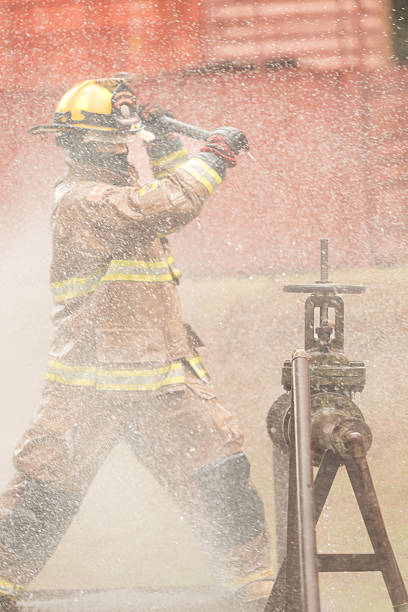 Three firefighters preparing to extinguish the fire outside