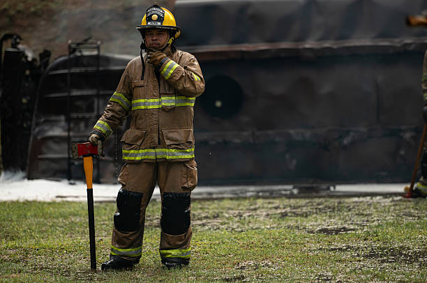 istock A firefighter in full turnout gear runs across a wet training ground while carrying a rescue axe 2247381391