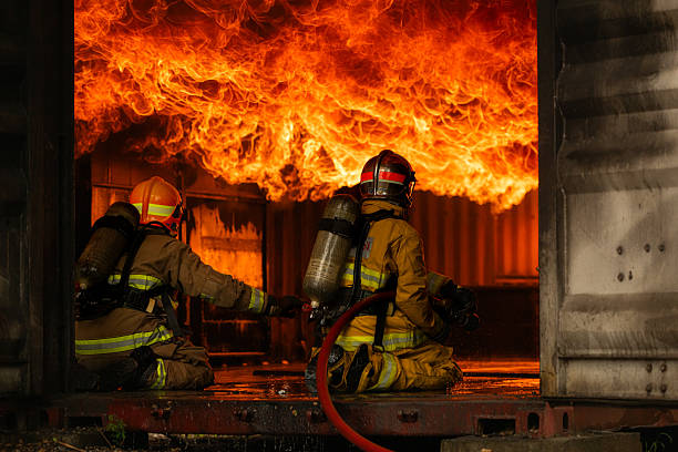 istock Two firefighters in full protective gear work together to extinguish a massive blaze 2247381611