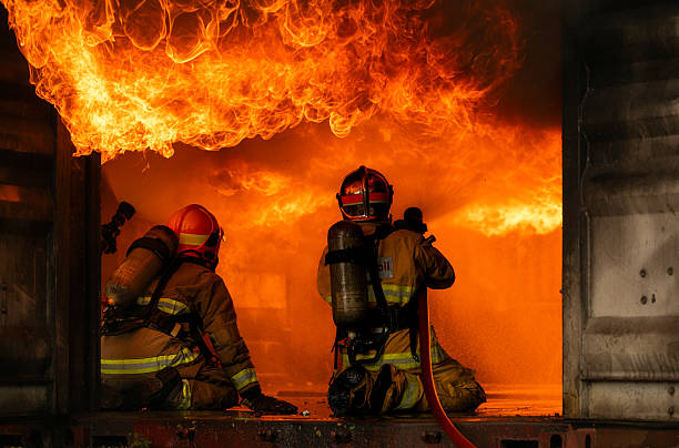 istock Two firefighters in full protective gear work together to extinguish a massive blaze 2247381623