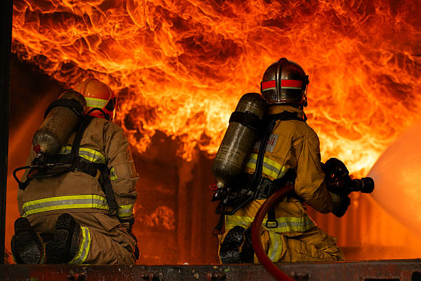 istock Two firefighters in full protective gear work together to extinguish a massive blaze 2247381631