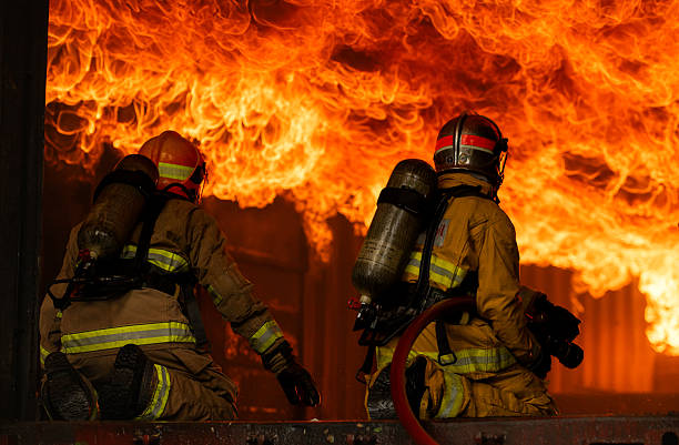 istock Two firefighters in full protective gear work together to extinguish a massive blaze 2247381633