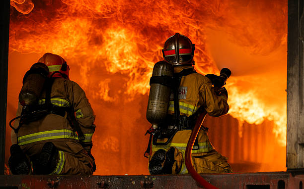 istock Two firefighters in full protective gear work together to extinguish a massive blaze 2247381634