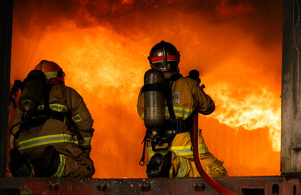 istock Two firefighters in full protective gear work together to extinguish a massive blaze 2247381636