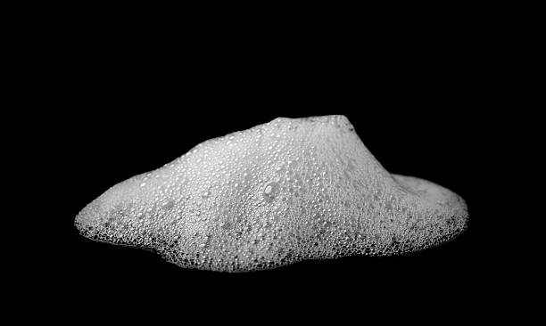 istock White soap foam and bubbles isolated on black background. Realistic frothy texture for cleaning products, cosmetic ads, hygiene concepts, overlays, and graphic design elements. 2247382324