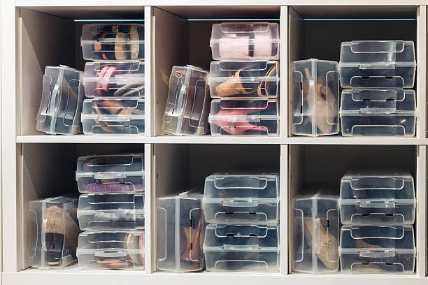 istock Clear plastic shoe storage boxes neatly arranged in organized closet cubby shelving system 2247385967