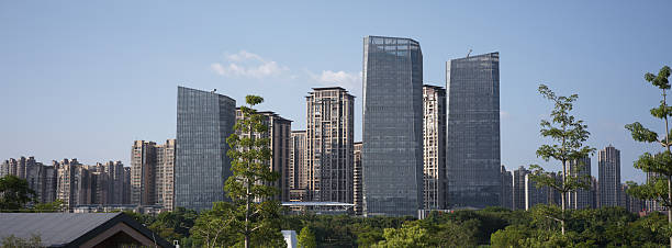 istock Modern Urban Skyscraper Cluster Surrounded by Green Trees and Natural Landscape 2247389227