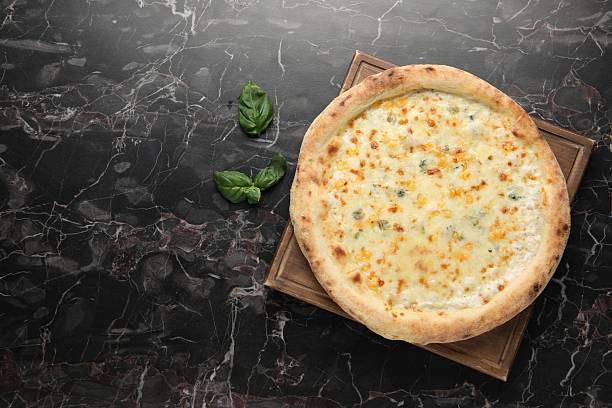 istock Delicious cheese pizza and basil on black marble table, flat lay. Space for text 2247390847