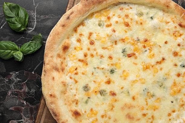 istock Delicious cheese pizza and basil on black marble table, flat lay 2247390898