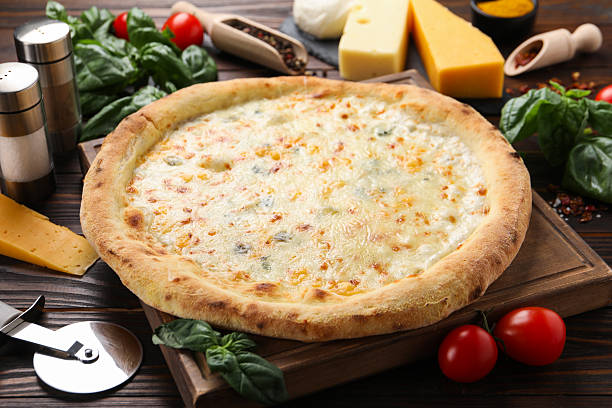 istock Delicious cheese pizza and ingredients on wooden table 2247390918