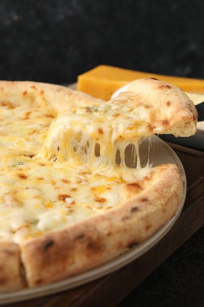 istock Taking piece of delicious cheese pizza at table, closeup 2247390984