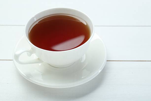 istock Aromatic tea in cup on white wooden table 2247391692