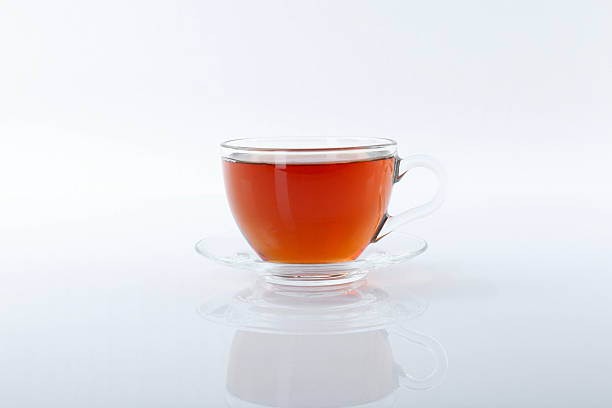 istock Tasty tea in cup on white background 2247391695