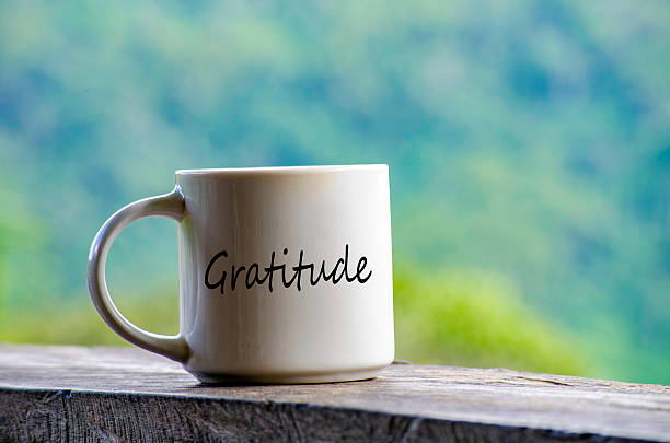 istock Gratitude text on a mug with nature beauty background. 2247393005