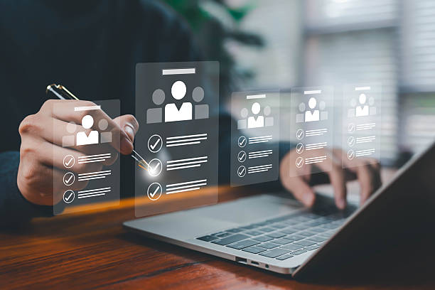 istock Hands selecting digital candidate profiles on a laptop, symbolizing recruitment, HR management, employee evaluation, hiring process, and talent selection in modern digital workforce systems online job 2247393951