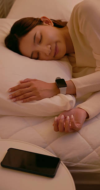 istock asian female wear smart watch sleeping home 2247395413